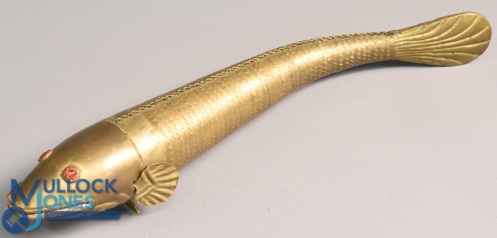 Vintage brass articulated 'Medina Fish' 10" in length with red paste eyes, complete example with