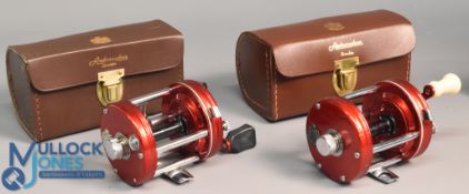 2x Fine ABU Ambassadeur 6000 multiplier reels both in red finish, feet stamped 020500 and 057009 -
