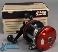 ABU Ambassadeur 5000 multiplier reel foot stamped 84-287-86, star drag level wind, in red, c/w