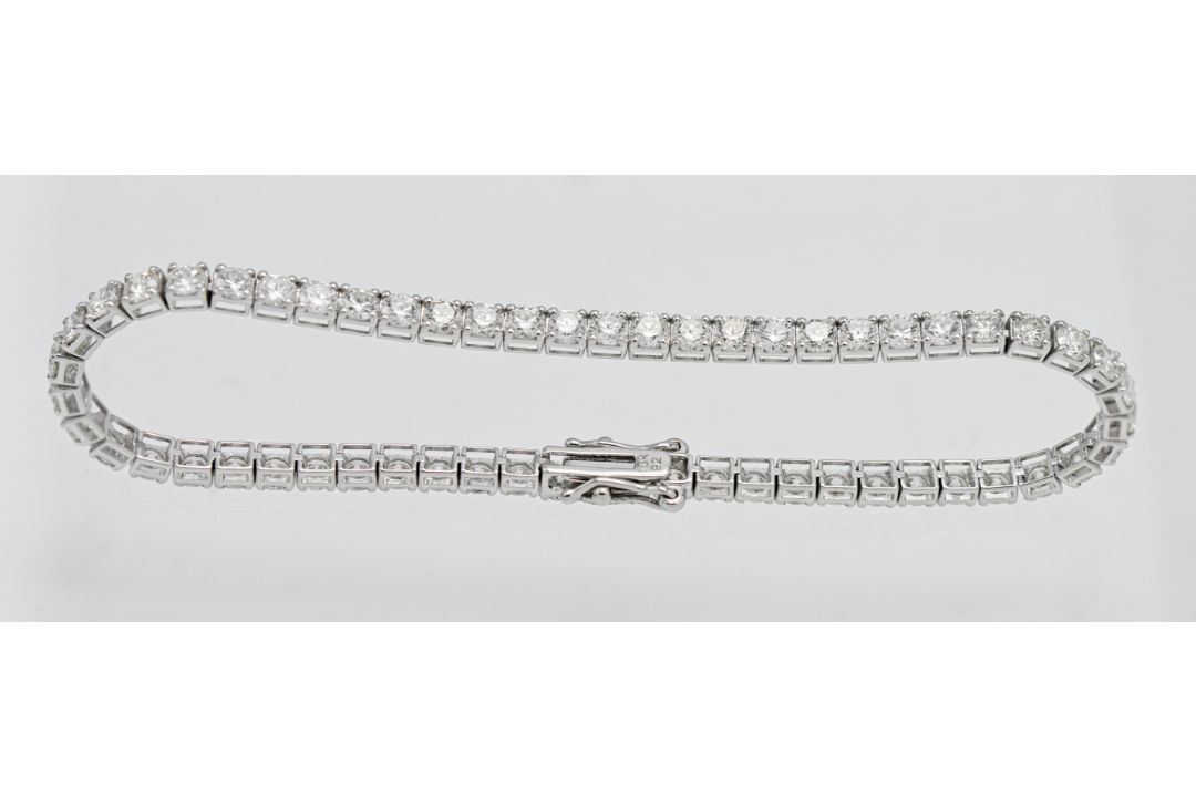 A diamond line bracelet set with fifty six diamonds approx. 5.6ct, set in 18k white gold, length