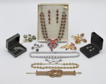 A collection of costume jewellery including brooches, necklaces etc.