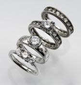 Selection of 4 CZ silver rings 2 of which are a matching set
