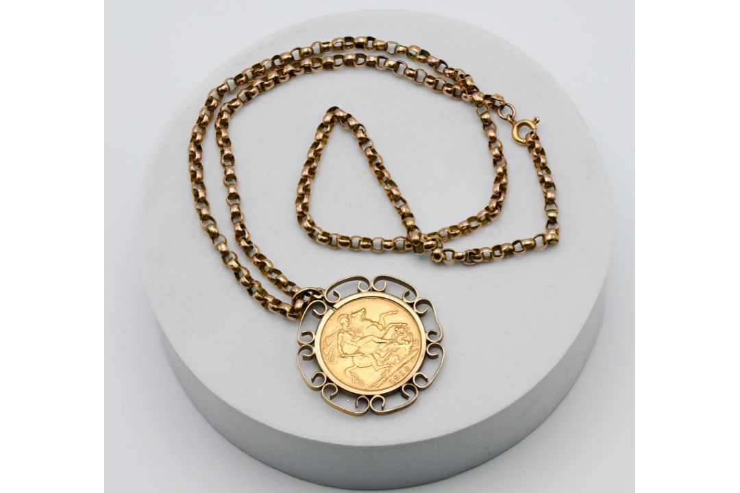 A 1910 Edward VII full sovereign mounted, on a 9ct gold chain, approx. 18.3g total.