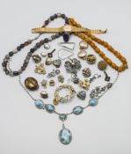 A mixed collection of costume jewellery including brooches, clip on earrings, necklaces also a