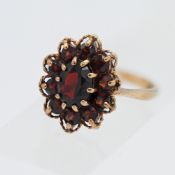 A 9ct red coloured stone cluster ring, 3.9g