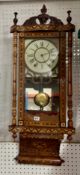 A Victorian parquetry inlaid wall clock with bell strike and brass face pendulum (probably American)