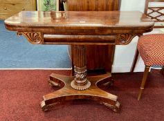 A late Regency mahogany fold over card table on pedestal platform base, top cross banded with a
