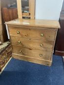 An old pine chest fitted with three drawers with brass knob handles on a plinth base, 88cm