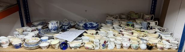 A large collection of Victorian and later china wares including sauce boats, pottery jugs, blue
