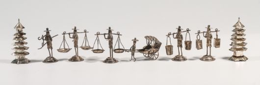 A Chinese silver cruet set comprising; six miniature of ‘farmer’ figures, three balancing a