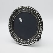 A modern silver circular photo frame diameter 21cm, maker DR & S