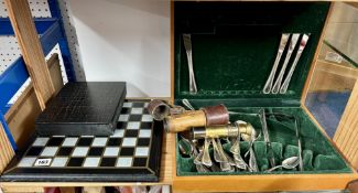 A modern silver plated canteen of cutlery, a chess board and pewter chess set, also a two pull