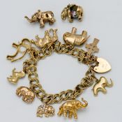 A 9ct gold double curb charm bracelet with nine attached charms (some hallmarked) and two loose