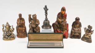 A wood figure of a seated deity, 18th/19th century, carved wearing long robes and a high