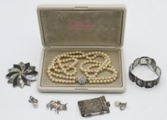 A collection of items including novelty cow pendant, brooches, vintage white metal notepad, QEII