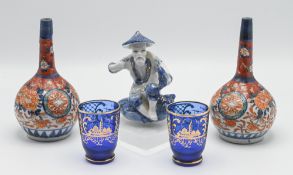 A pair of Chinese Imari bottle vases, 18th century, the globular body below a tall slender neck