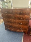 An early 19th century mahogany bow fronted chest fitted with two short and three long drawers,