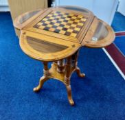 Continental mahogany and inlaid games table with four drop flaps, removable games board with glass