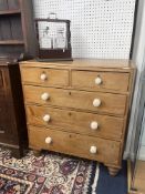 An early 20th century pine chest fitted with two short and three long drawers with china white