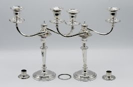 A pair of silver twin branch candelabra, hallmarked London circa 1934, makers mark RC together