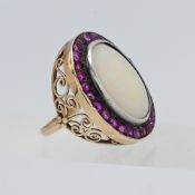 A large and impressive opal and ruby cluster ring set in unmarked yellow gold, size M