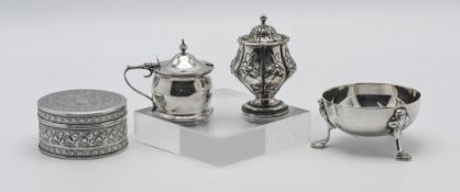 A small silver bowl on three feet, an ornate silver pepper pot, a silver George V mustard pot (6.