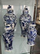 A pair of 19th/20th century Chinese blue and white porcelain jars and covers each with four
