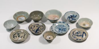 A group of seven blue and white provincial ware bowls and four saucers, 10.5 to 15..3cm.
