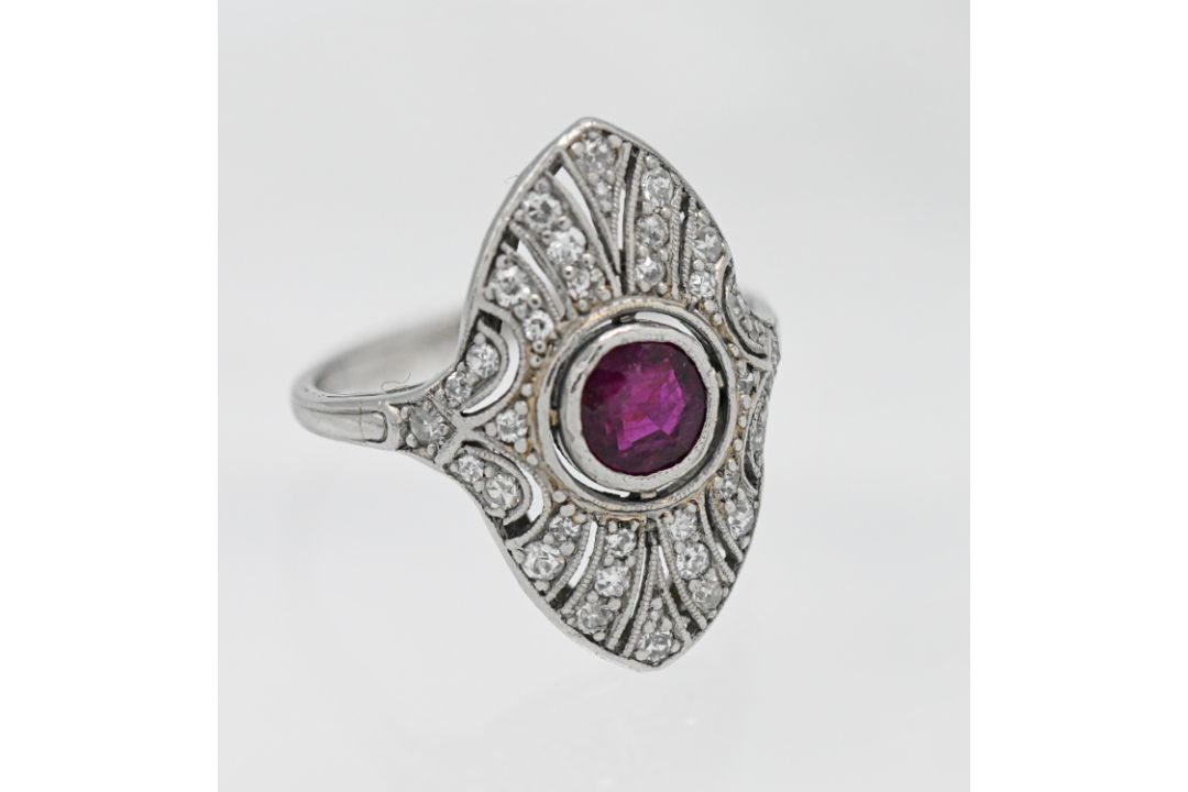 A 1920's platinum ruby and diamond cluster ring, size J.