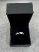 A platinum diamond set 'D shaped' band with polished finish. Diagonal stripe with 7 diamonds.