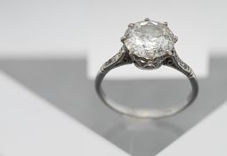 A large diamond ring set, with six smaller diamonds to the shoulders, size L/M, hallmarked rubbed.