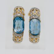 A pair of 14ct gold topaz and diamond earrings.