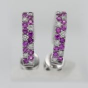A pair of 18ct white gold diamond and pink sapphire hoop earrings.