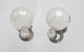 A pair of pearl and diamond clip on earrings (The Pearl Company).