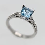 An 18ct white gold topaz and diamond ring, size N.