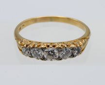 An 18ct yellow gold five stone diamond ring, finger size Q.