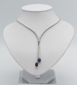 A stunning diamond line necklace set in 18ct white gold, further set with a large single ruby and