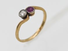 An 18ct yellow gold diamond and ruby twist ring, size N.
