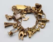 A 9ct gold charm bracelet with approx twenty one charms, approx 61.9g