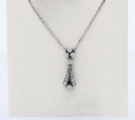 An elegant diamond drop pendant set in platinum on fine chain.