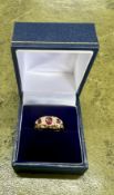 An 18ct yellow gold diamond and ruby ring, size M/N