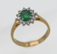 An 18ct yellow gold diamond and emerald cluster ring, size O/P.