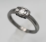 An 18ct diamond three stone ring set in white gold, size M/N.