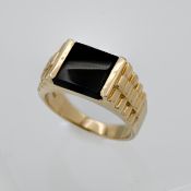 A 14k yellow gold gents ring set with black stone, size P, approx weight 6.69g.