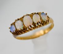 An antique yellow gold ring set with five opals (not hallmarked), size O.