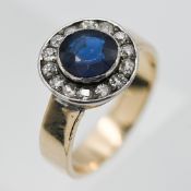 A sapphire and diamond cluster ring, centre round cut sapphire, set with old cut diamond surround,