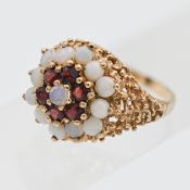 A large 9ct yellow gold opal and garnet dress ring, size Q.