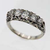 An 18ct white gold five stone set diamond ring, carved head, five modern brilliant cut diamonds,