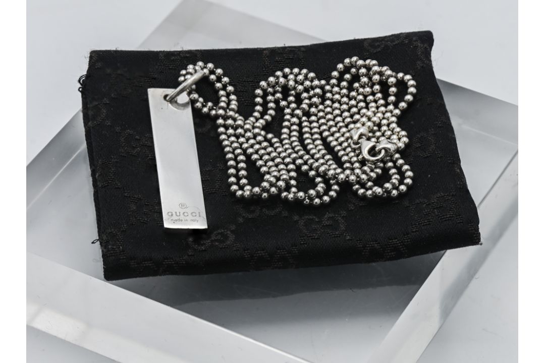 Gucci, a silver Gucci pendant on chain, with Gucci cloth pouch.