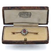 A ruby and diamond cluster brooch (not marked), approx weight 2.81g.